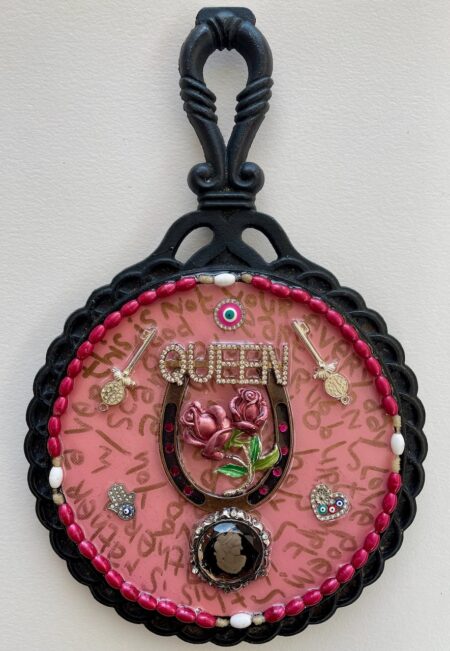 queen, roses inside horseshoe, evil eye, gold writing on pink backing; inside of iron mirror frame