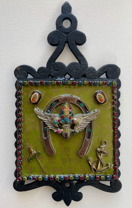 colorfully bejeweled shape with wings, horseshoe, acnhor, religious embellishments in bejeweled trim with writing inside of iron frame